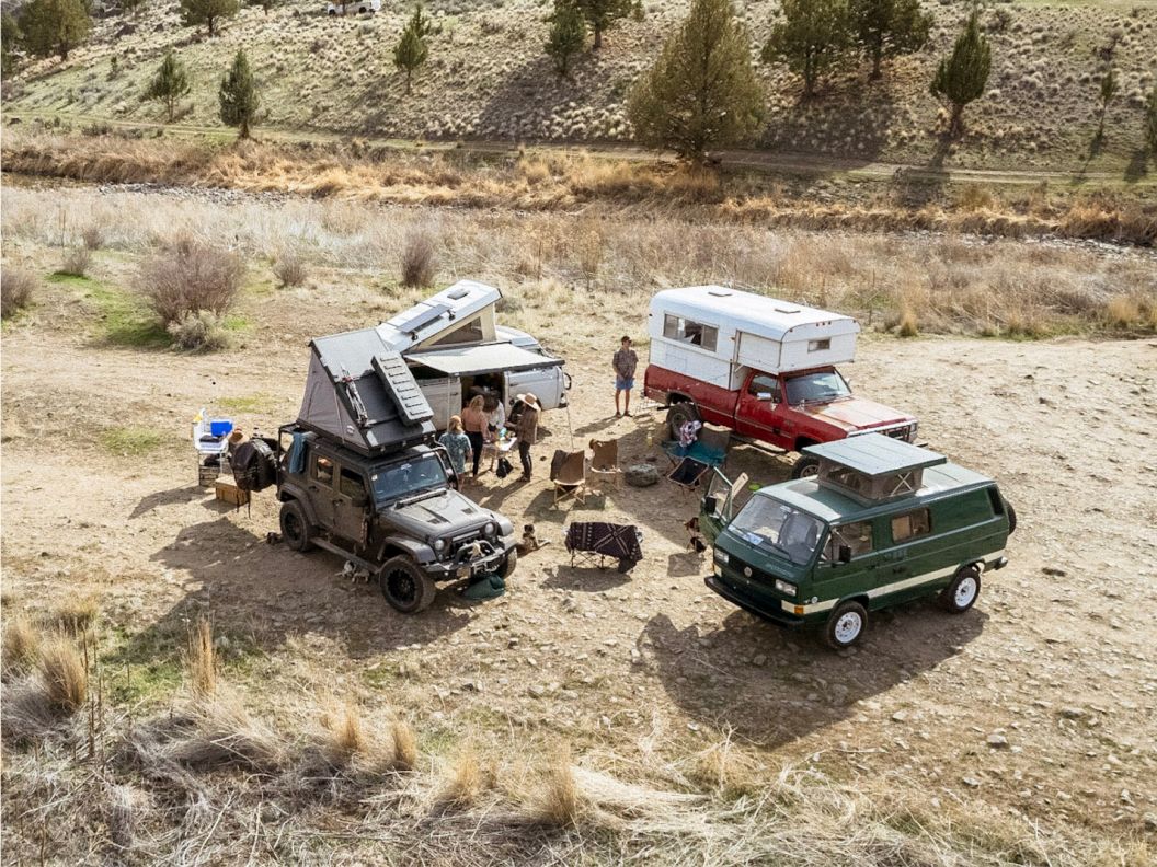 Overhead shot of camp vehicles spread throughout a campsite.