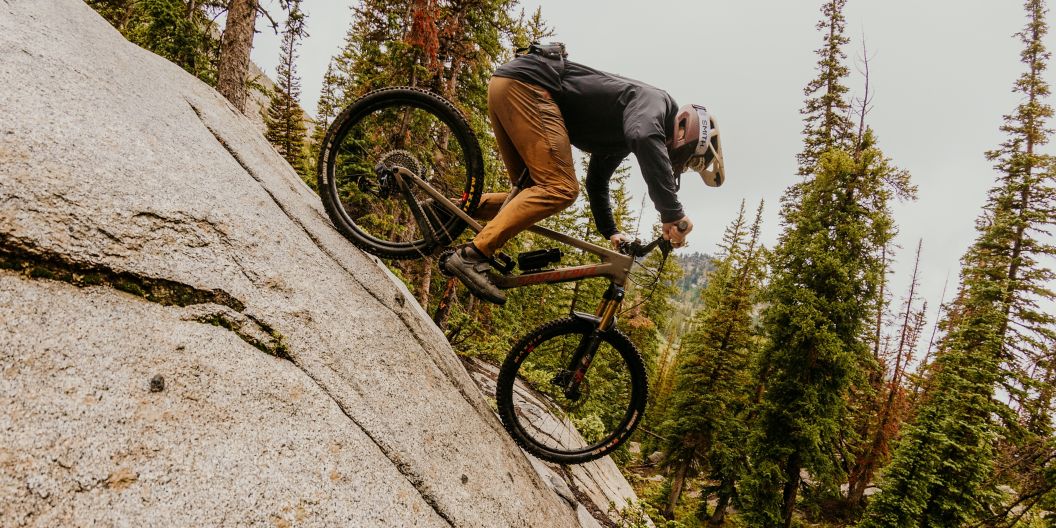 Mountain biker descending a slab of granite rock. 