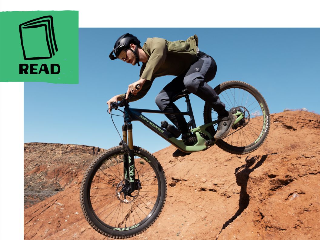 Mountain biker drops through the air with a desert mesa background. 