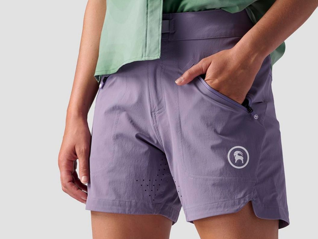A person wearing bike shorts with a hand in their pocket.
