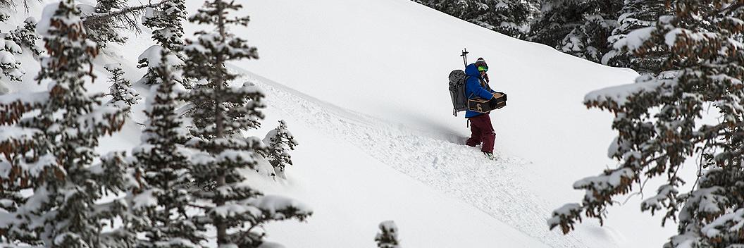 A snowboarder holding a return package