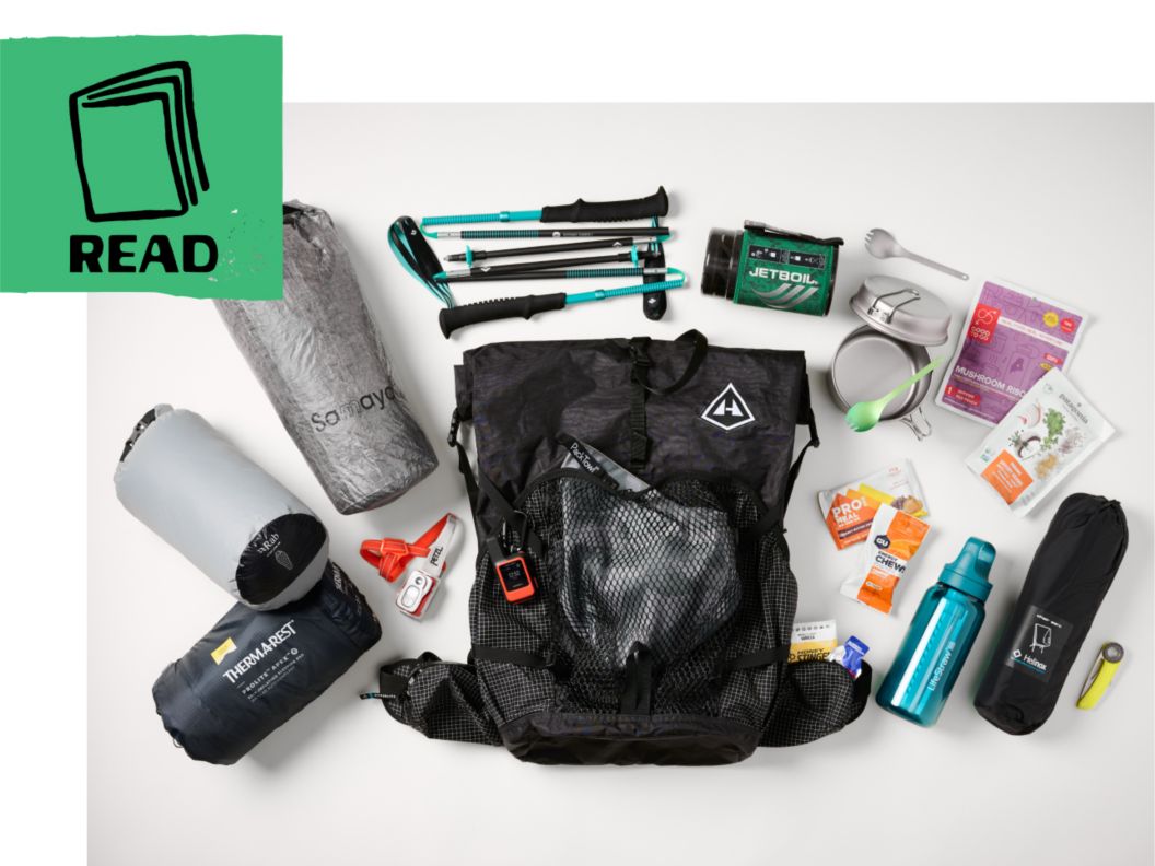 Backpacking gear spread out around a lightweight pack. A book icon and the word “read.” 