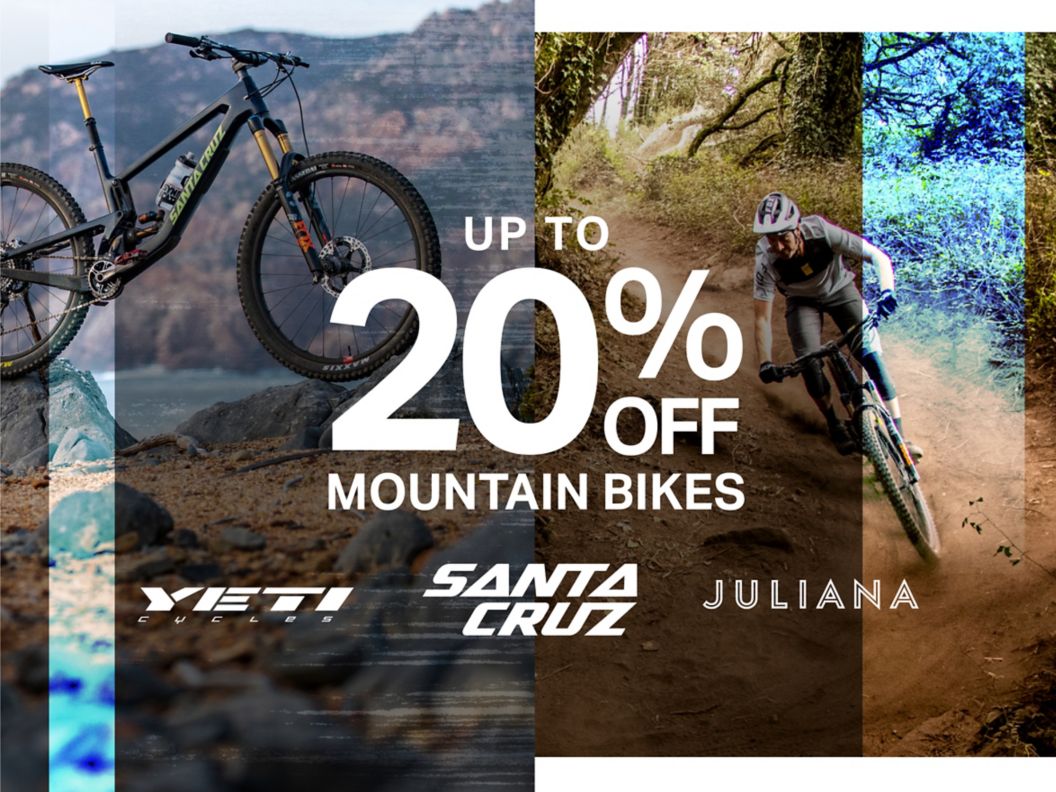 A mountain bike sitting on rocks and a cyclist riding down a dirt trail with superimposed text: Up To 30% Off Mountain Bikes, plus the logos of three brands: Santa Cruz, Juliana, and Yeti.