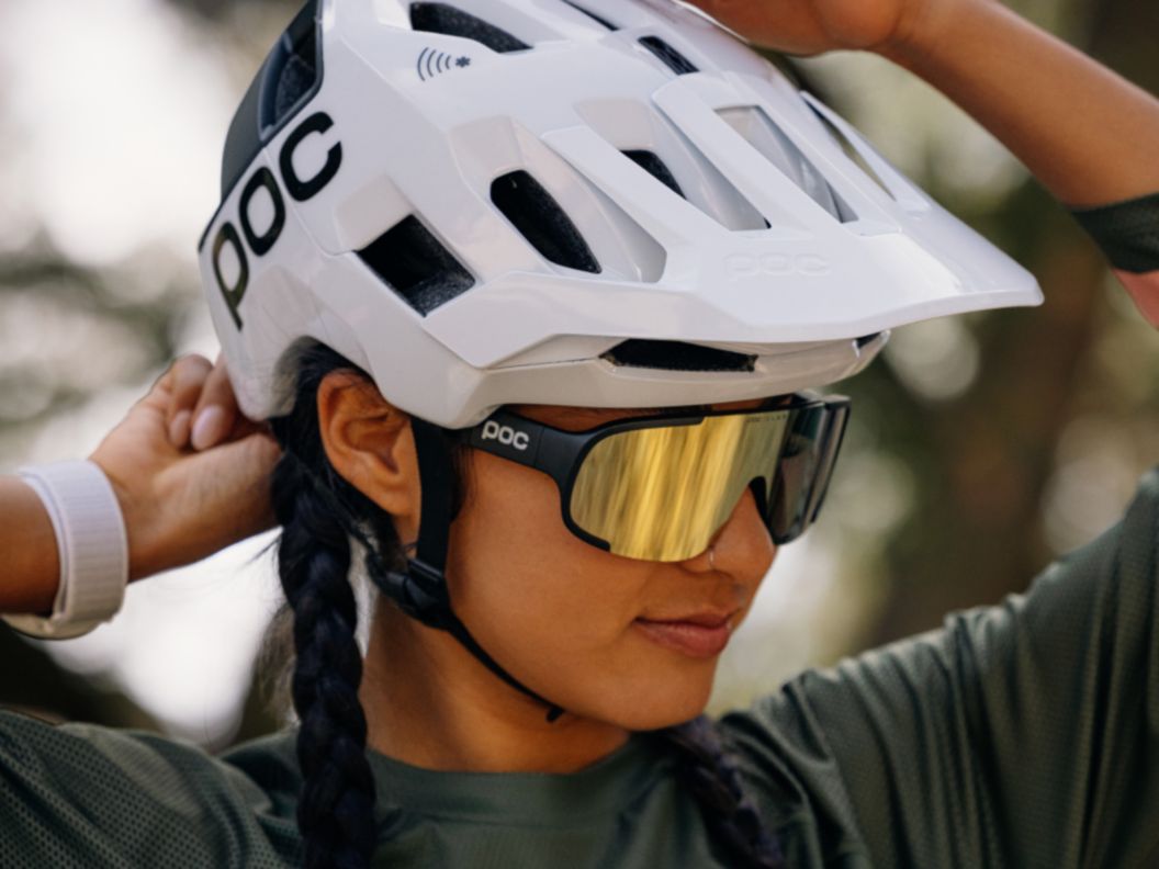 Mountain bike rider adjusting helmet