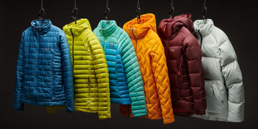 Six brightly colored puffy jackets suspended over a black background.