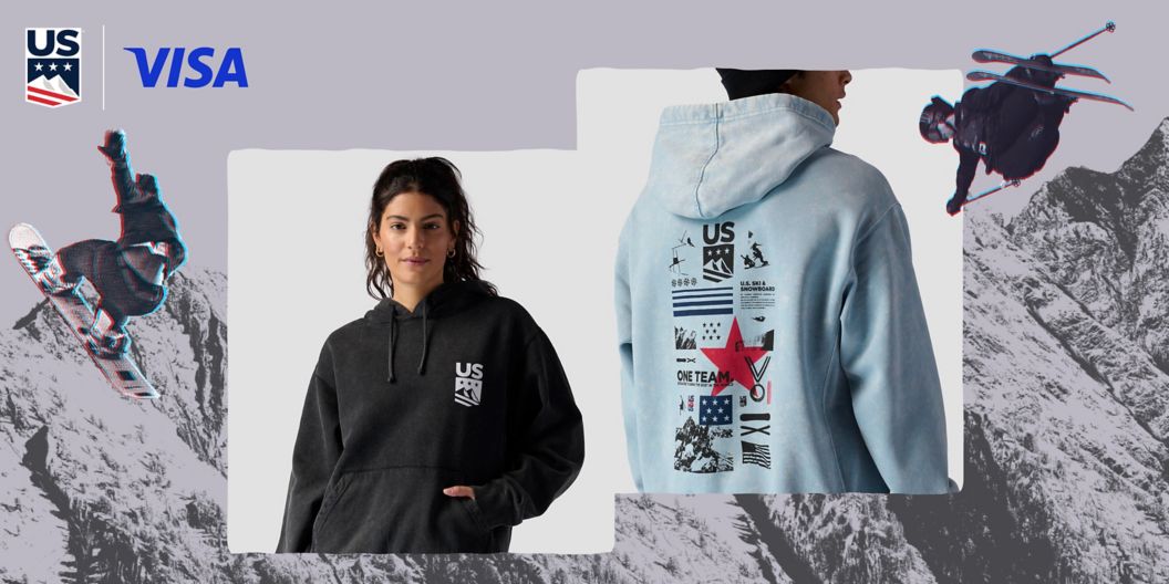 Two models show off new U.S. Ski & Snowboard hoodies. The upper right-hand corner shows off the teams’ logo along with their sponsor, VISA.