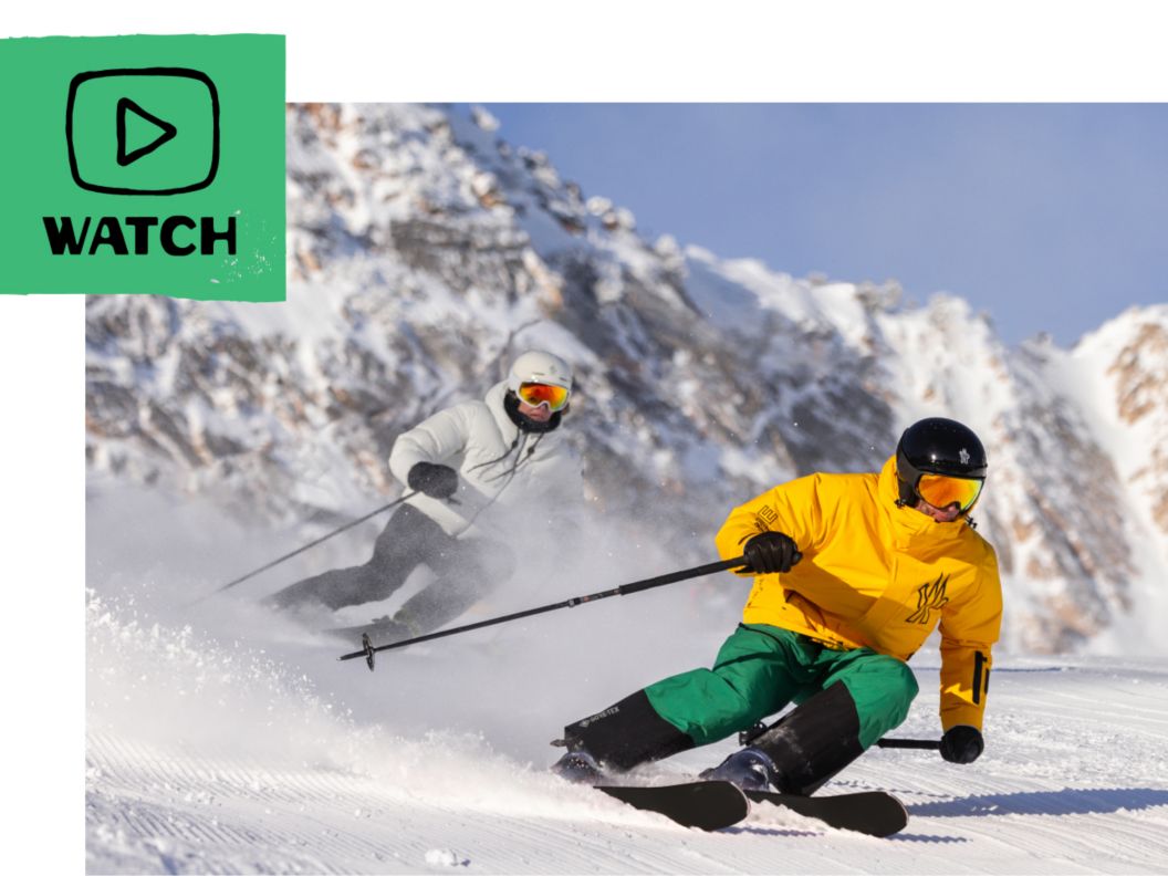 Two skiers wearing Moncler skiwear carve on a groomer. A play button icon and the word “watch.” 