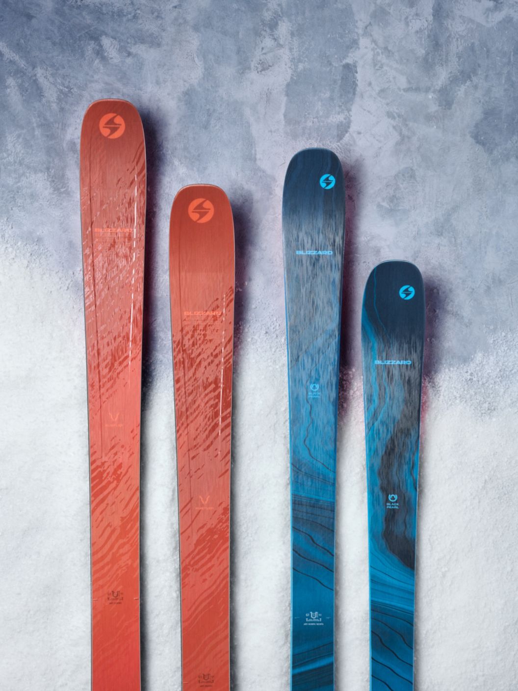 A pair of Blizzard Hustle 10 skis next to Blizzard Black Pearl 88s. 