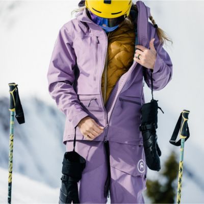 Woman zipping up ski jacket. 