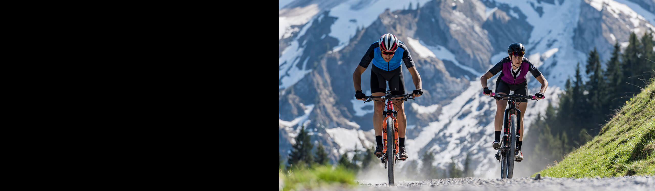 A couple of bike riders with mountain background