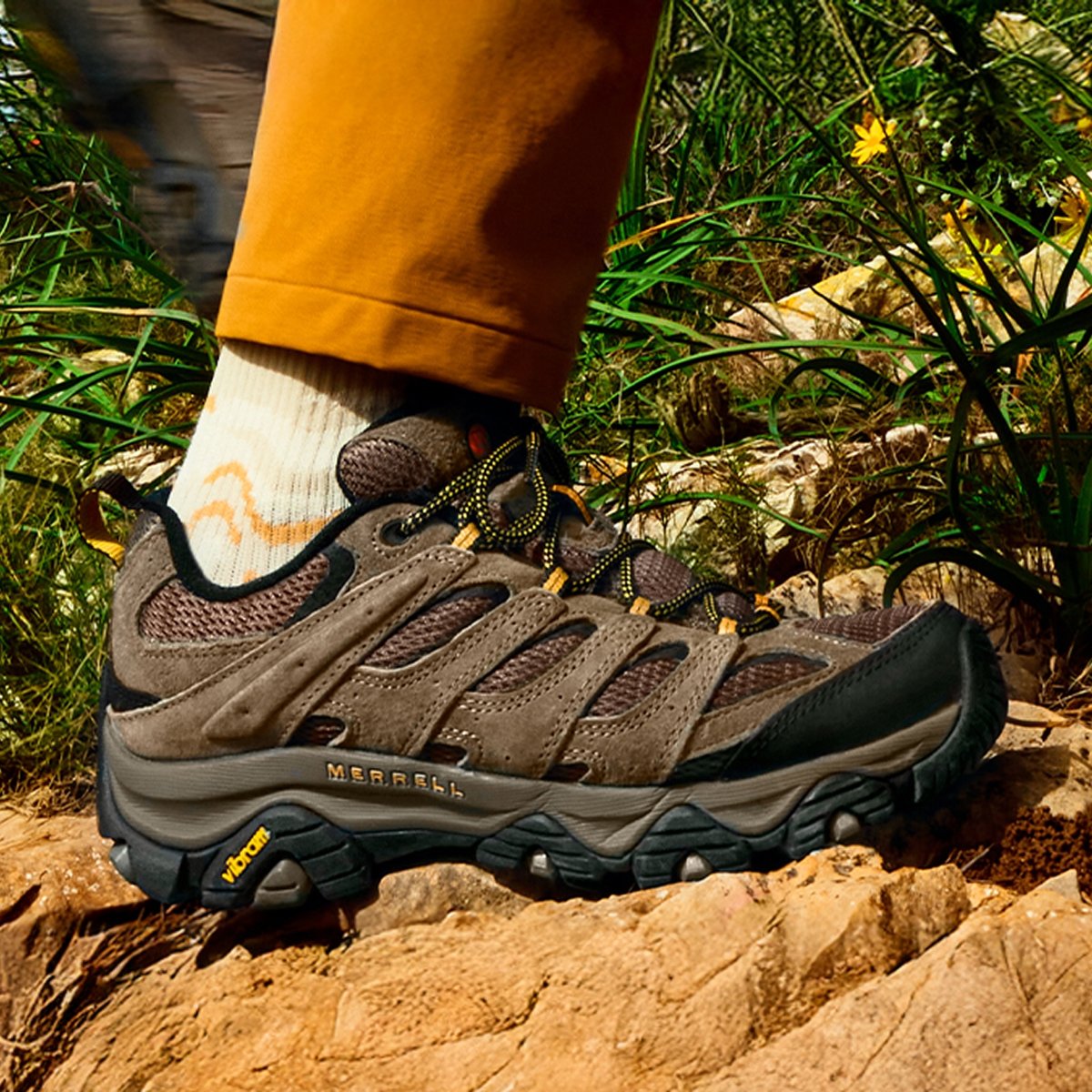 A brown leather hiking shoe, the classic Merrell hiking style. 