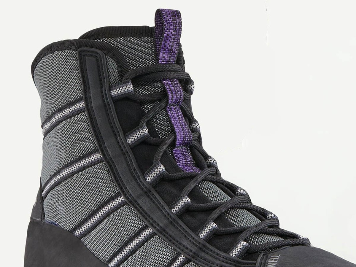 Close-up of the boot's collar and lacing area, showing purple pull tab, black cord laces, and reflective grey ripstop upper on white background.