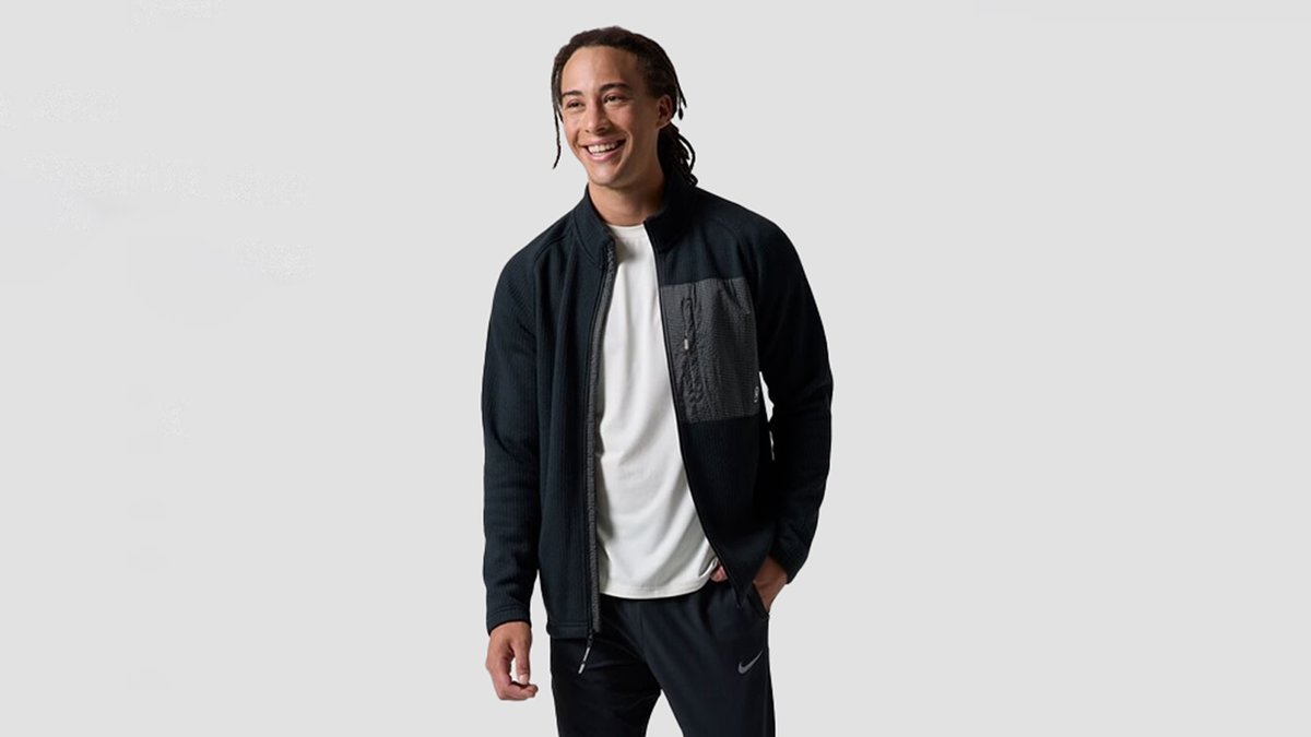 A man wears the BGA Wander Sweater Fleece Jacket.