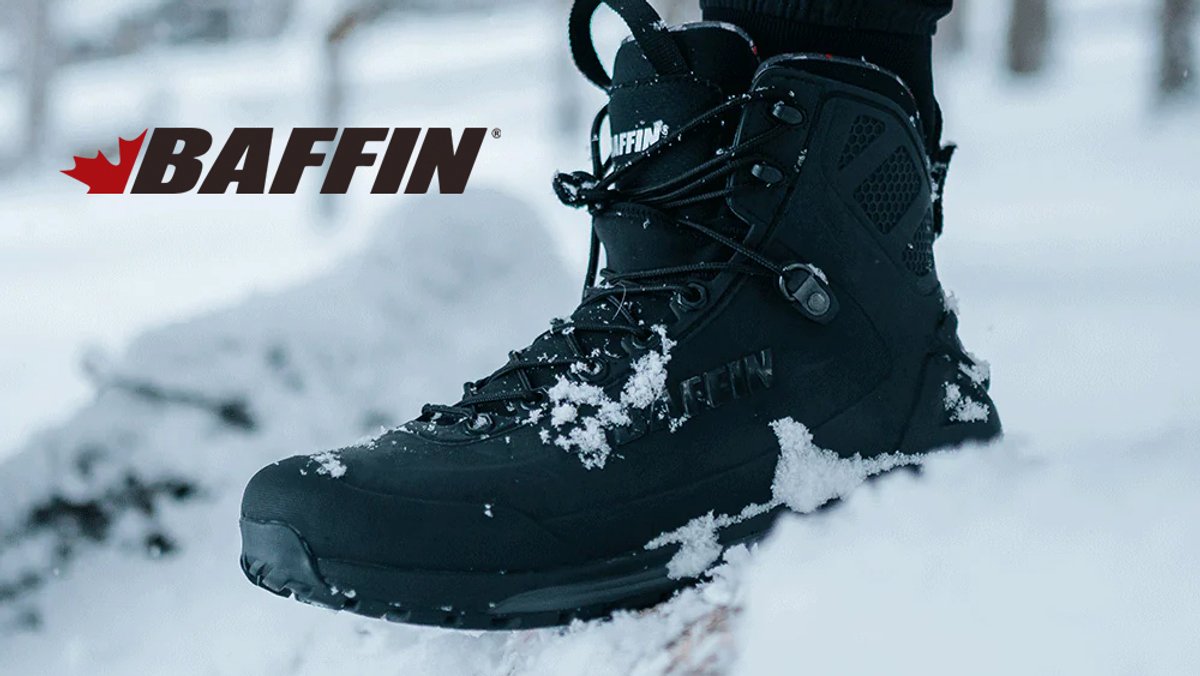 Black Baffin winter hiking boot with snow coverage standing in deep snow, showcasing waterproof insulated design for cold weather outdoor adventures.