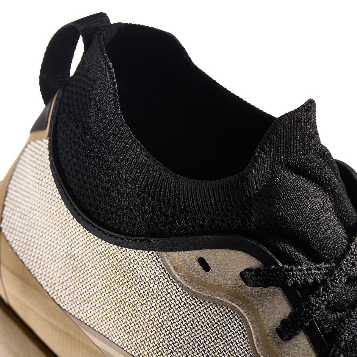 Side view of Norda trail shoes showing black knit ankle collar.