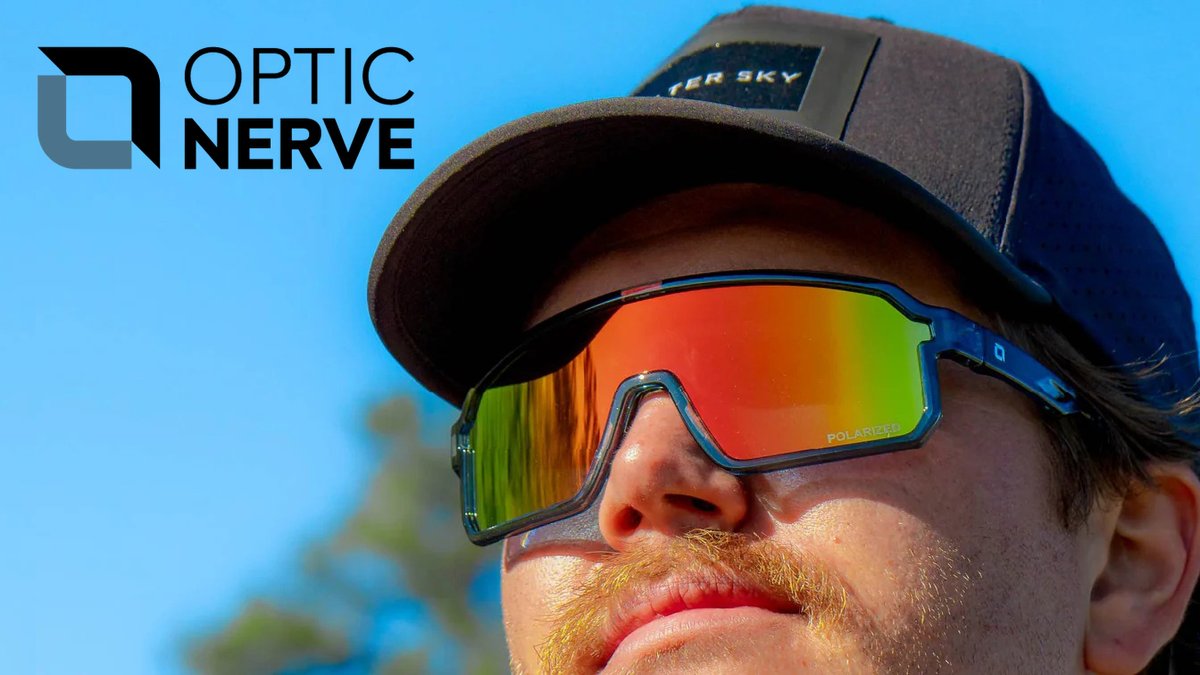 Man wearing Optic Nerve polarized sport sunglasses and baseball cap against bright blue sky background showcasing outdoor eyewear protection.