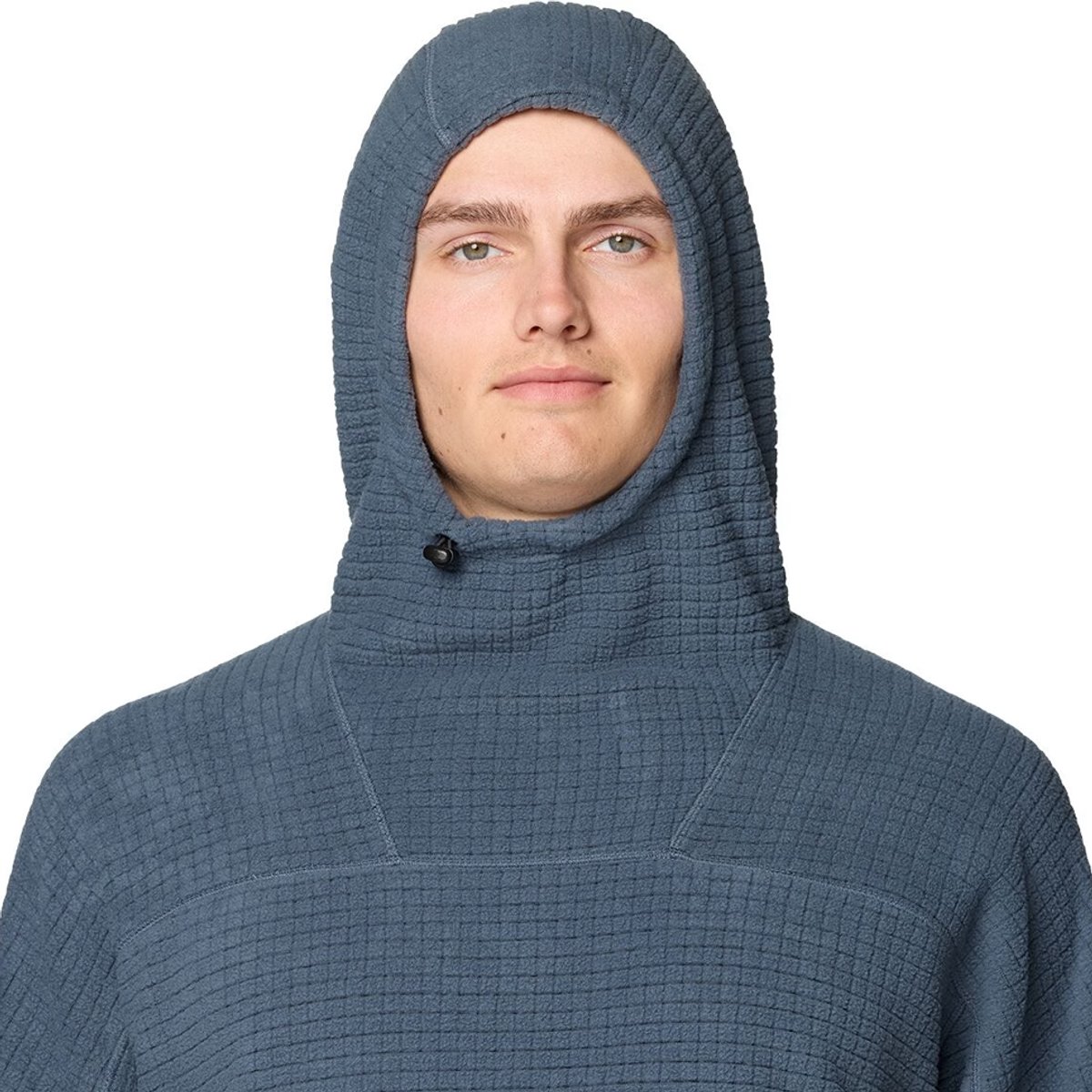 A closeup of a man wearing the Summit Grid Big Grid Hooded Jacket, with the hood on.