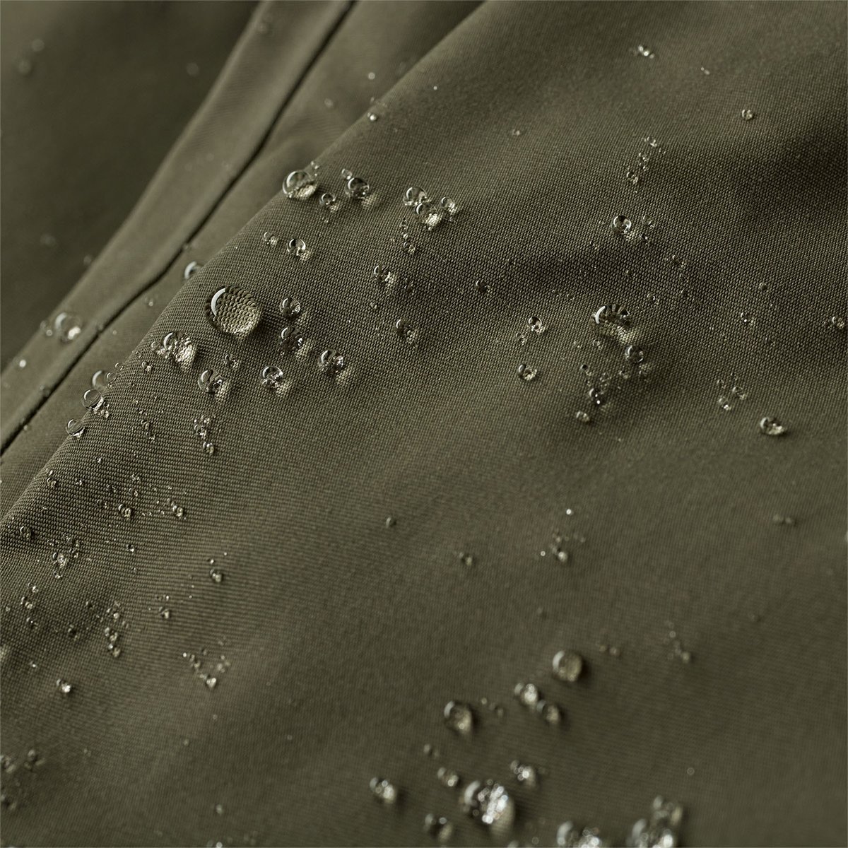 A closeup of the Swiftcurrent Jacket fabric, showing water beading off of it.