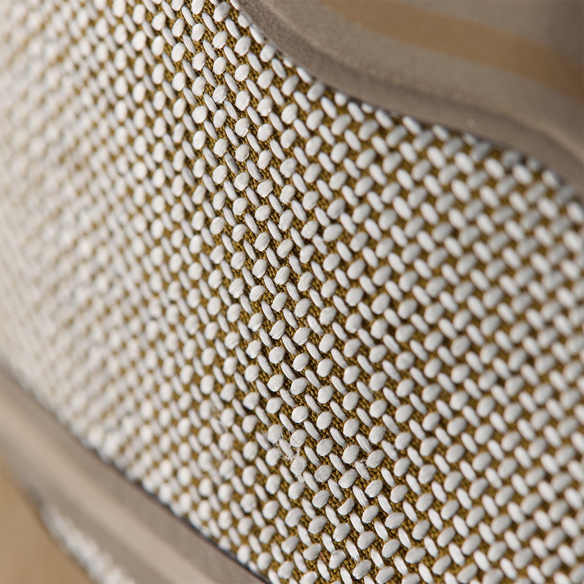 Extreme close-up of the Norda Dyneema woven upper showing the white-on-tan crosshatch weave structure.