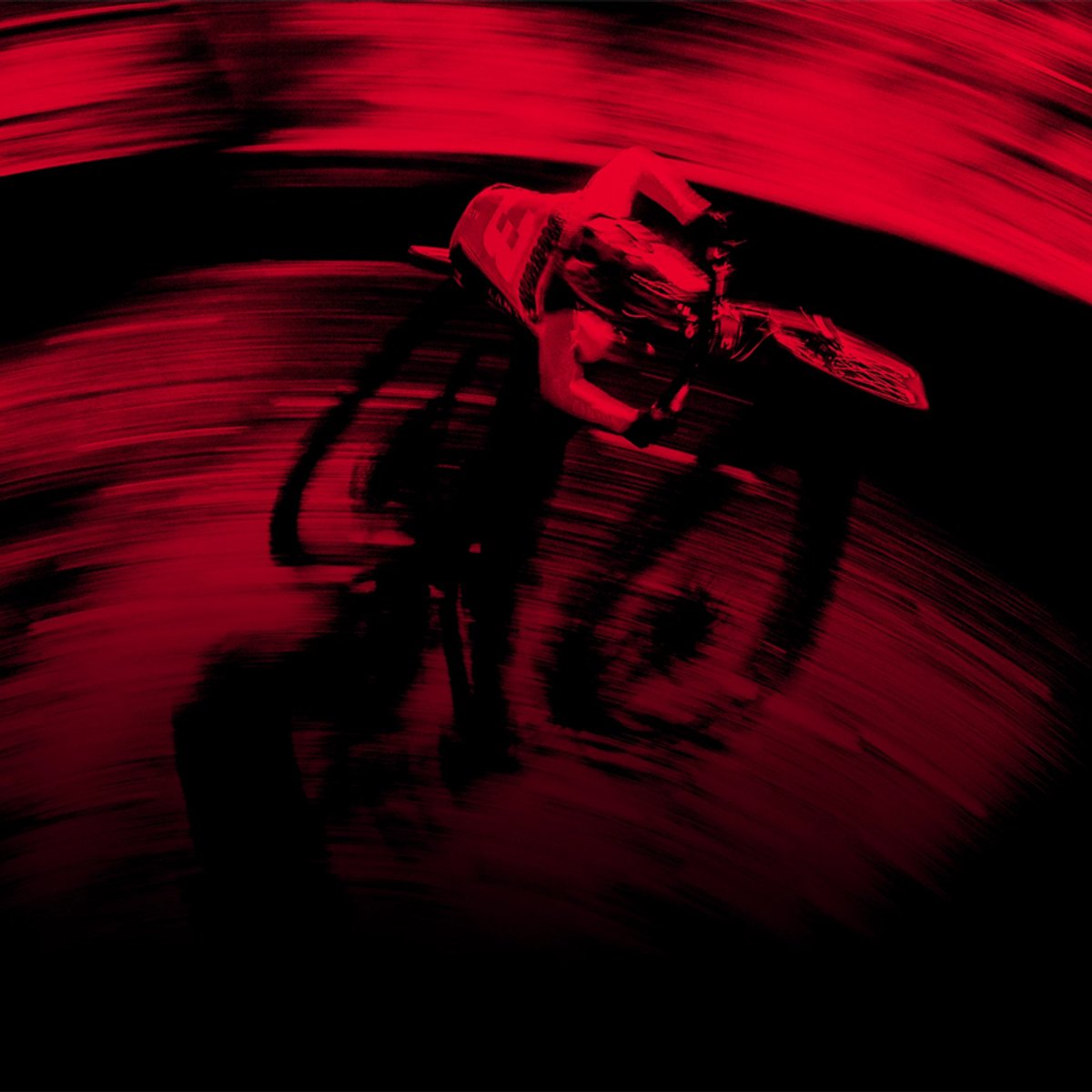 A rider flies past on their bike, with a red blurred overlay.