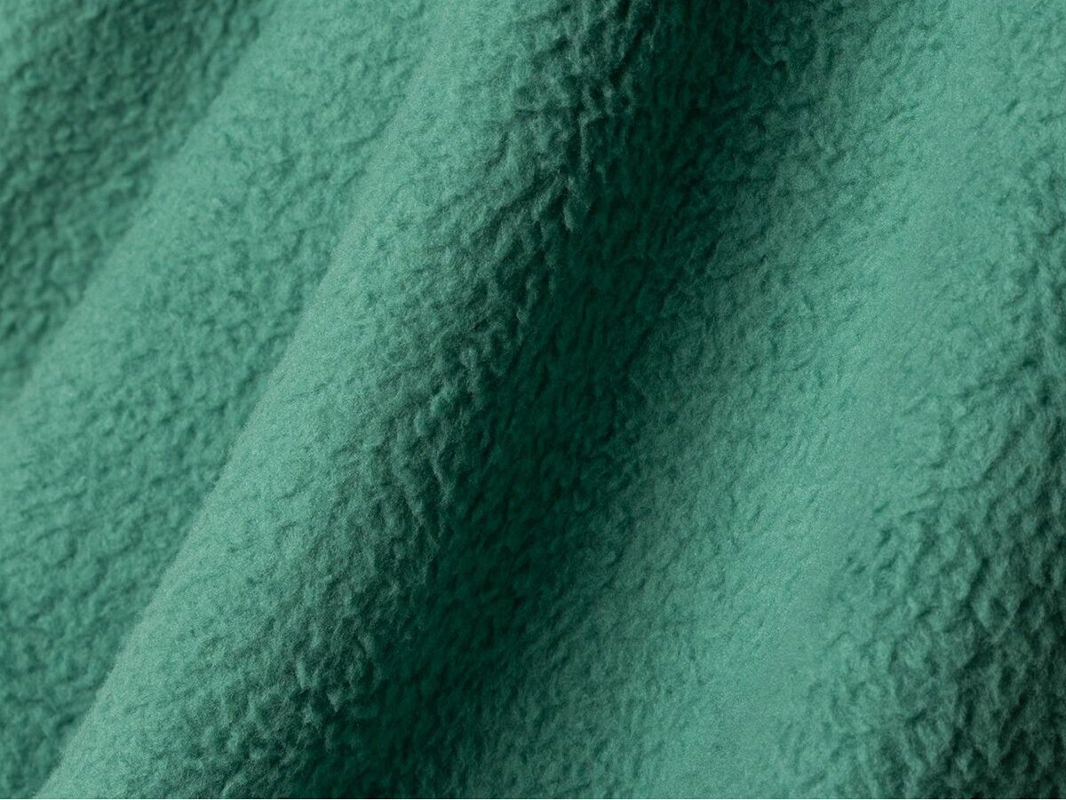Close-up of green fleece material with fuzzy texture.