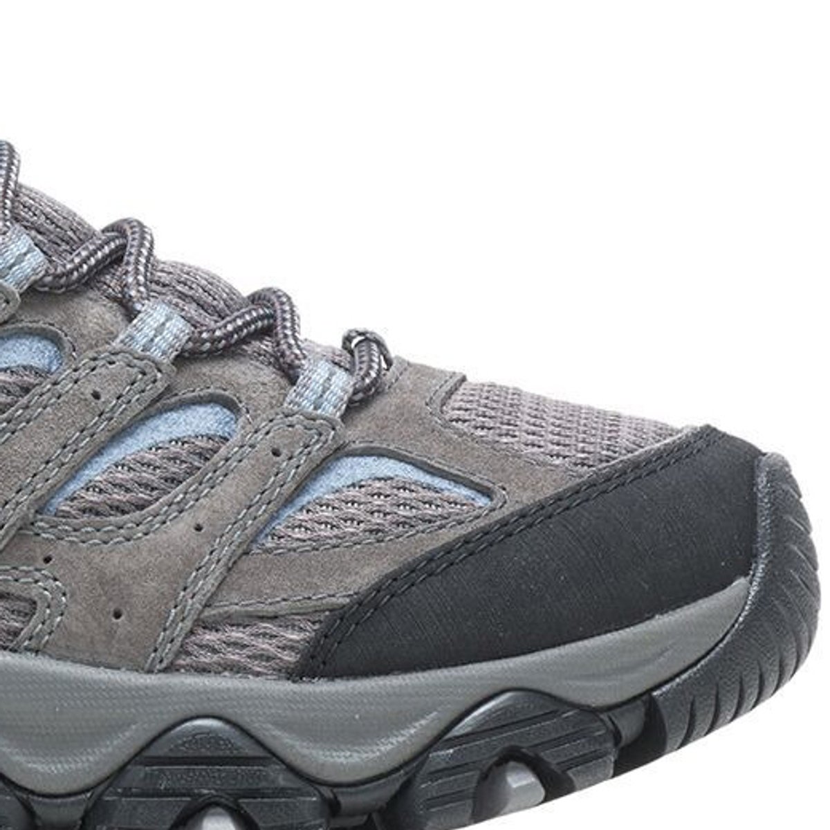Close-up of the toe box and midsole on a gray and blue Merrell hiking shoe, showing the rubber toe cap and lugged outsole.
