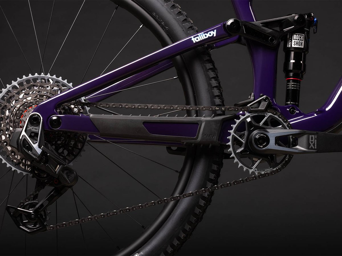 Detail of the Santa Cruz Tallboy's VPfree four-bar suspension linkage, showing the pivot points connecting the rear triangle to the carbon frame alongside a RockShox Luxe rear shock.