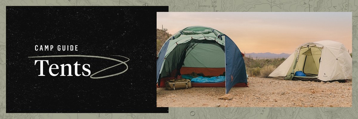 Two open tents air out in a sandy campsite. Desert hills rise in the background. Words appear to the left of the tents saying “Camp Guide, Tents”.