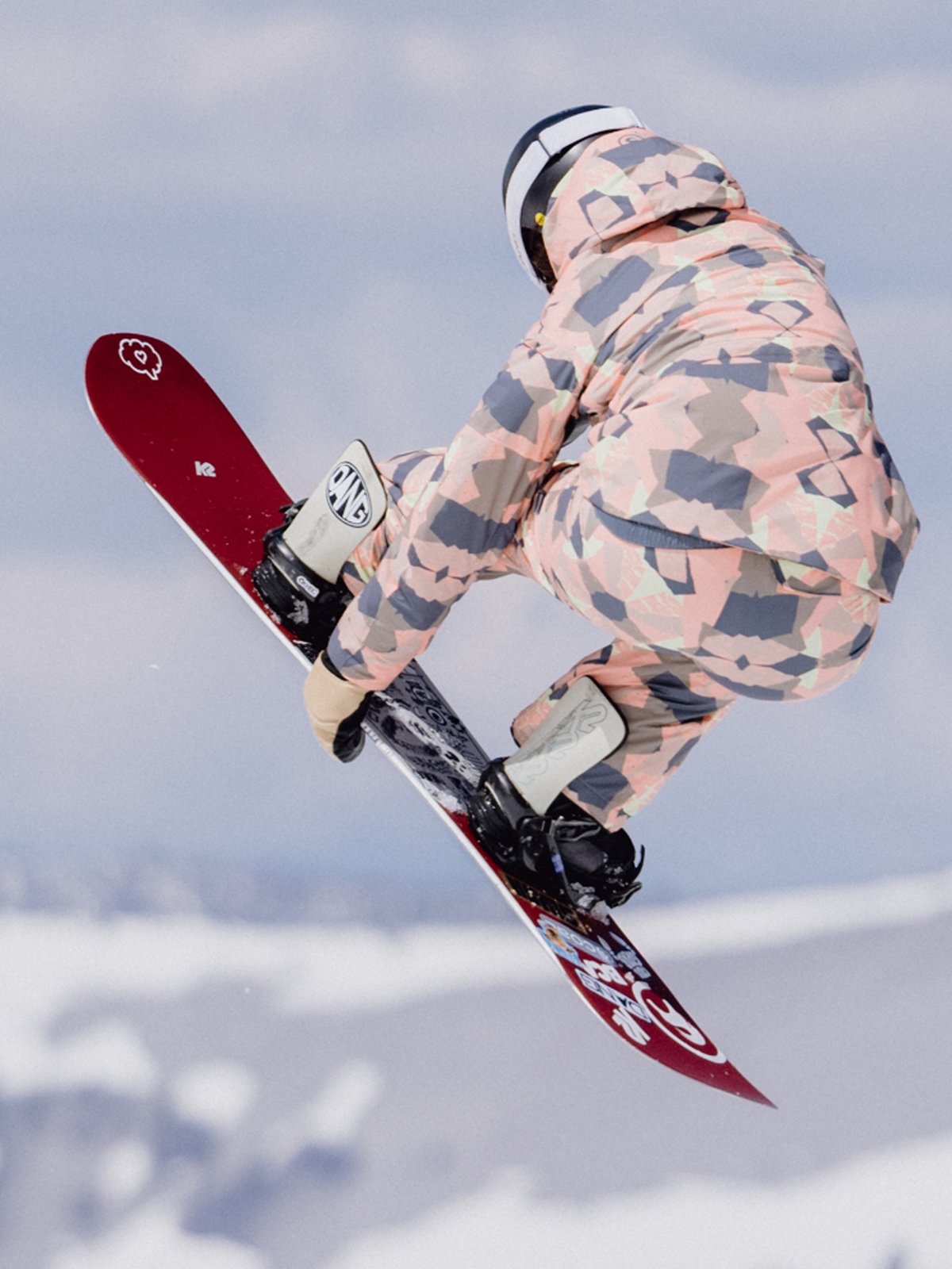 A snowboarder does a trick in the park.