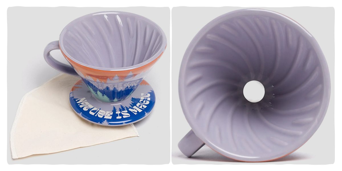 A ceramic coffee dripper with mountains and the words “Nature is Magic” painted on the exterior.