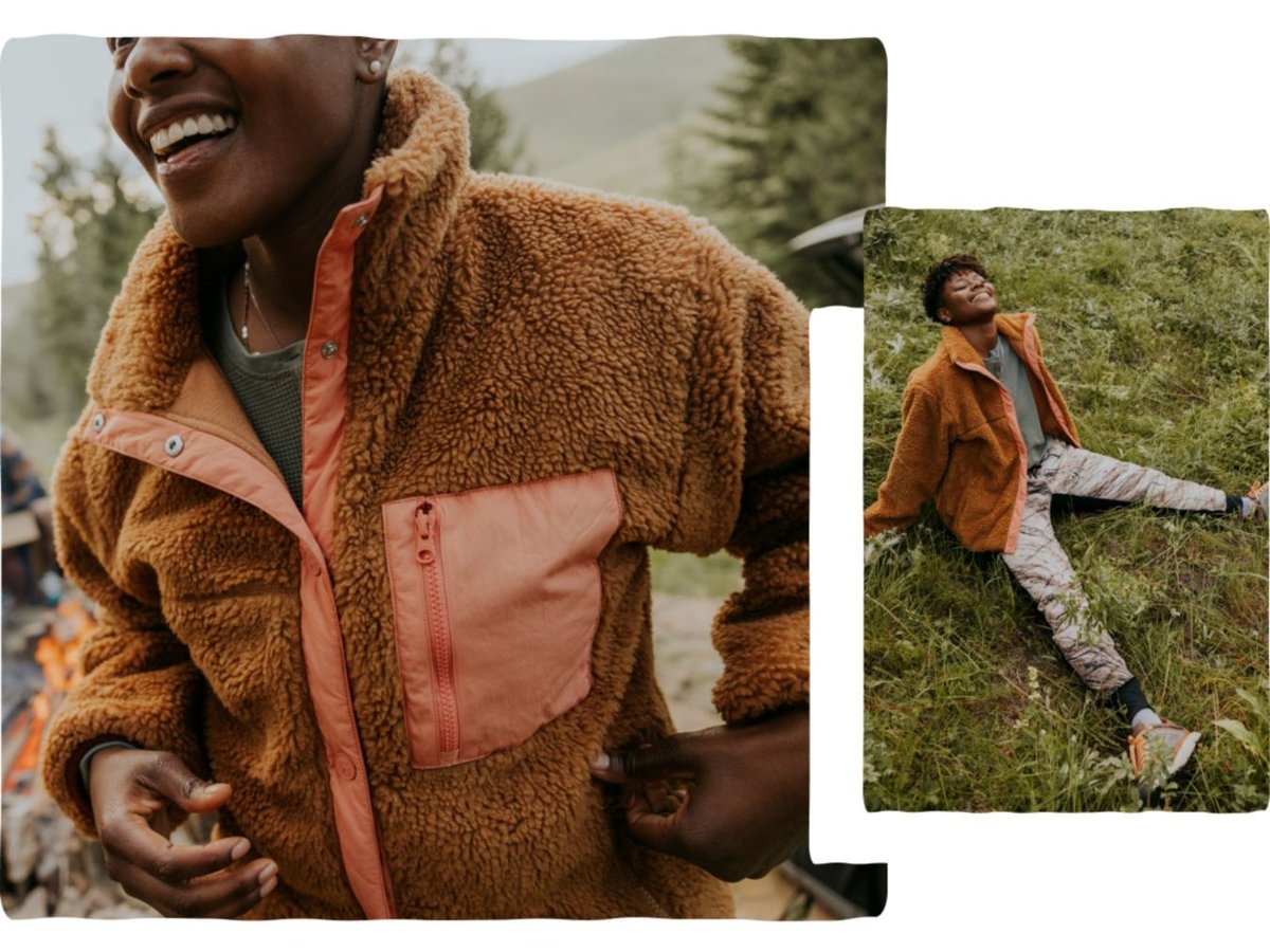 A person lays in the grass in their fleece.