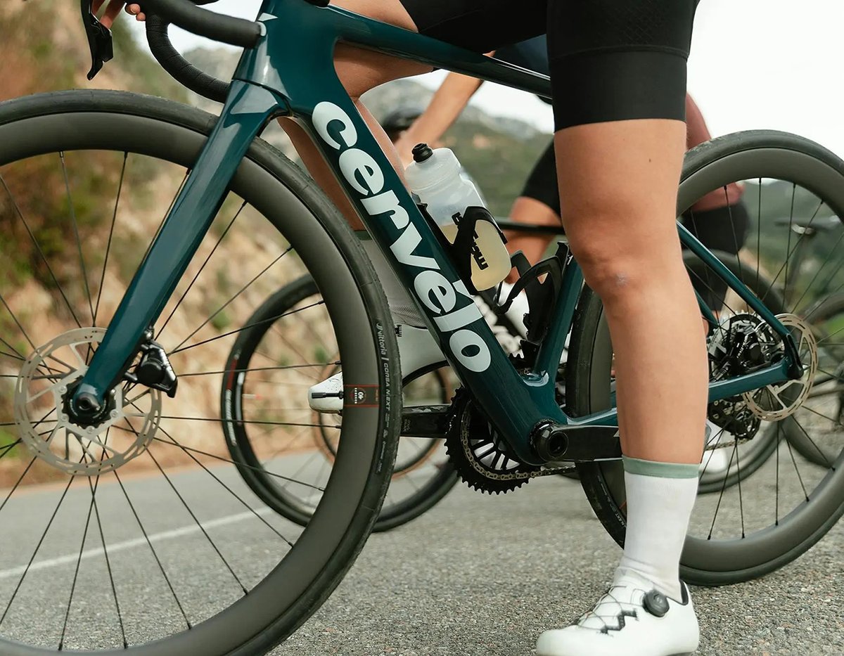 Close-up of a Cervélo road bike frame and wheels on a paved road.