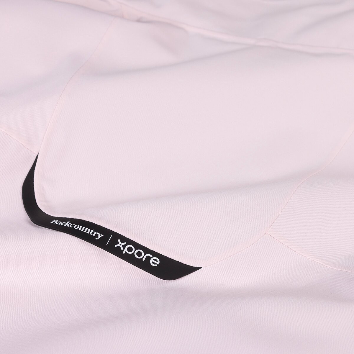 Close up detail shot of Backcountry Xpore branded ski kit face fabric.