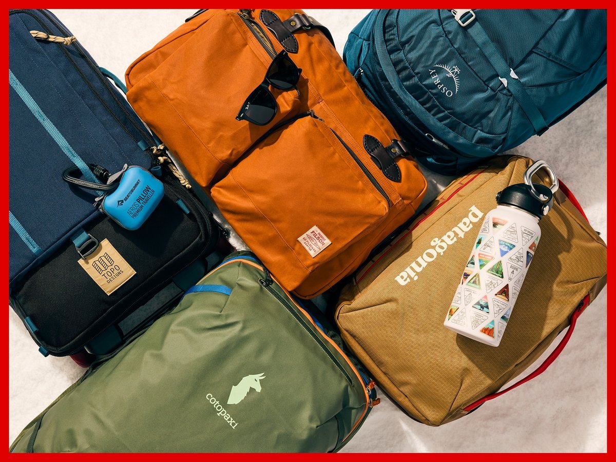 Five backpacks and duffel bags arranged on snow.