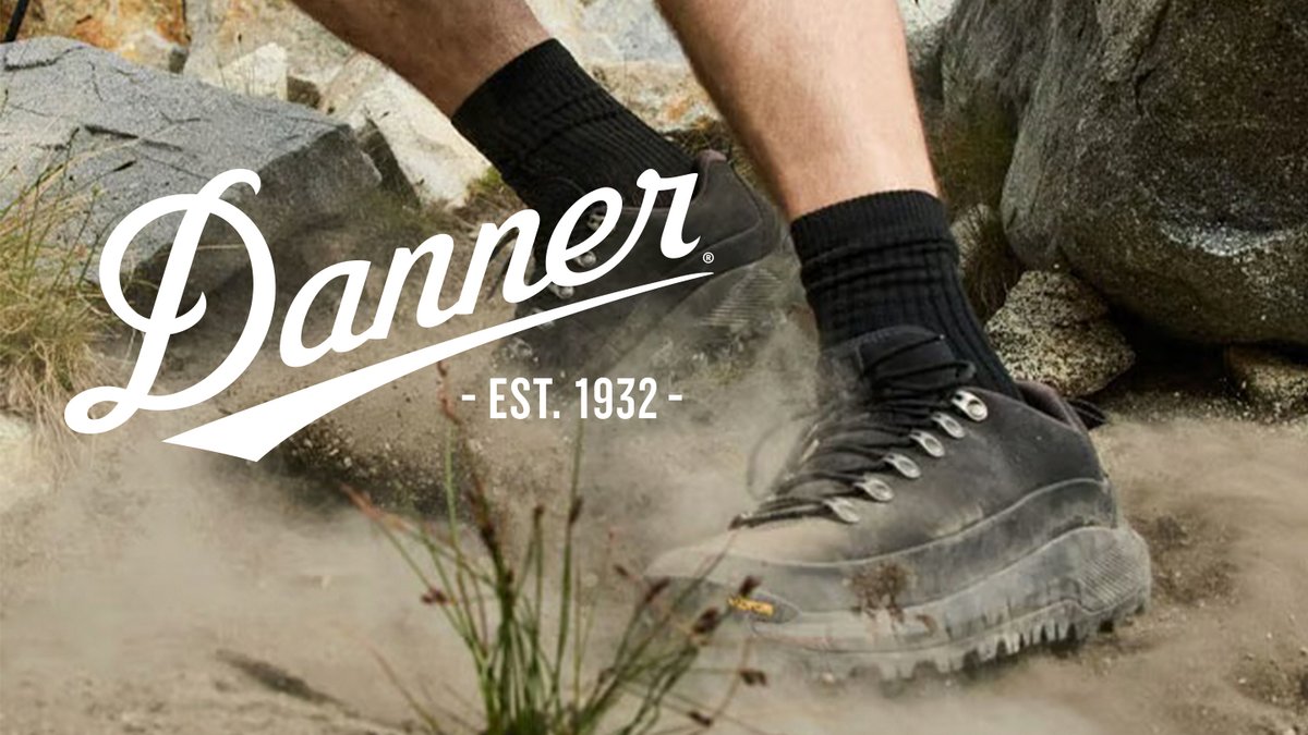 Danner hiking boots with black socks on rocky terrain showcasing established outdoor footwear brand heritage since 1932.