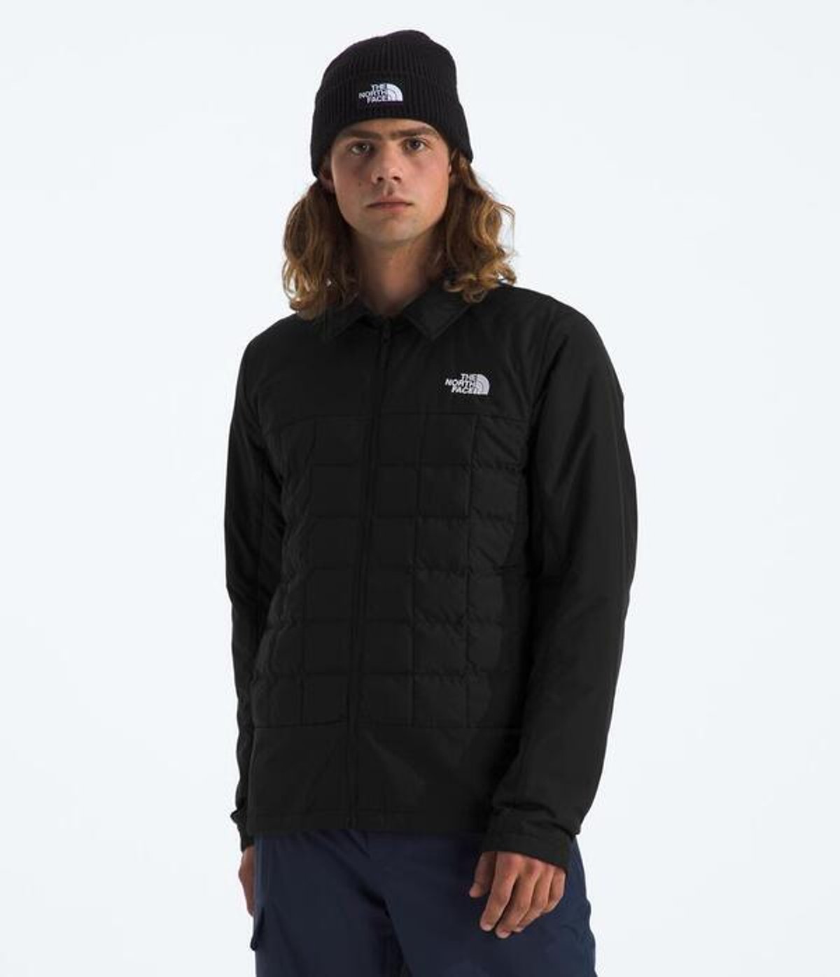 close-upo fperson standing facing forward wearing snow jacket and hat.
