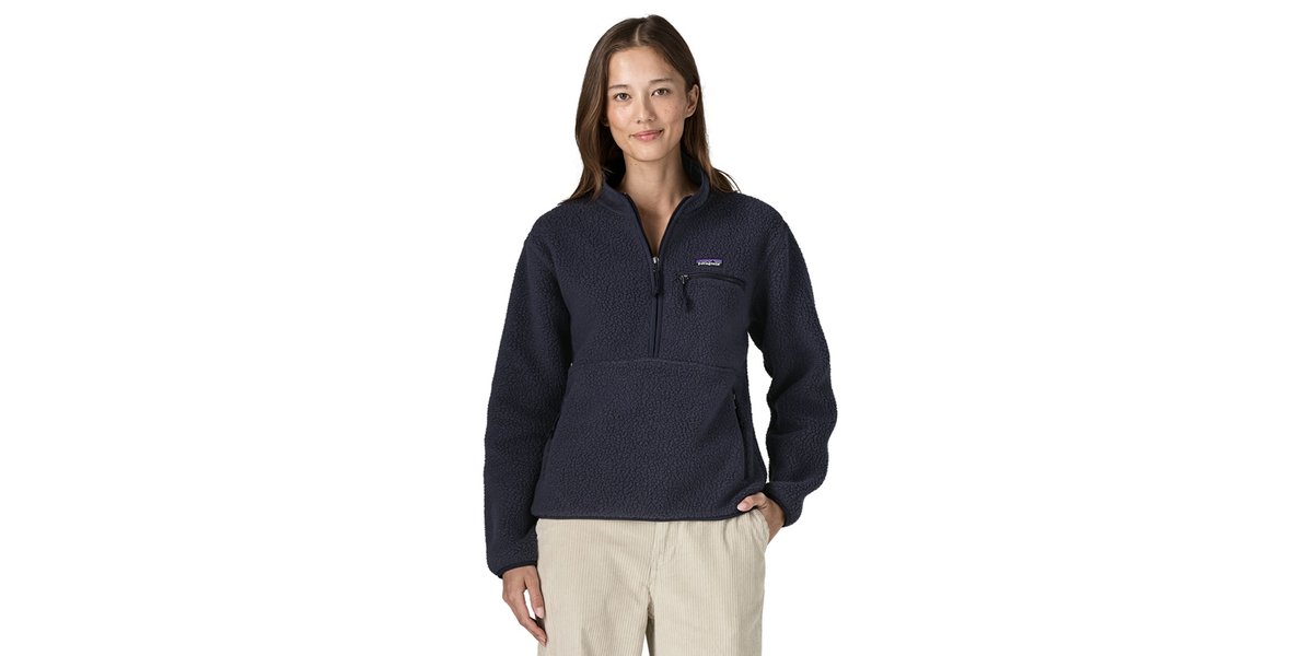 A woman wearing the Retro Pile Marsupial Pullover stands with her hand on her hip