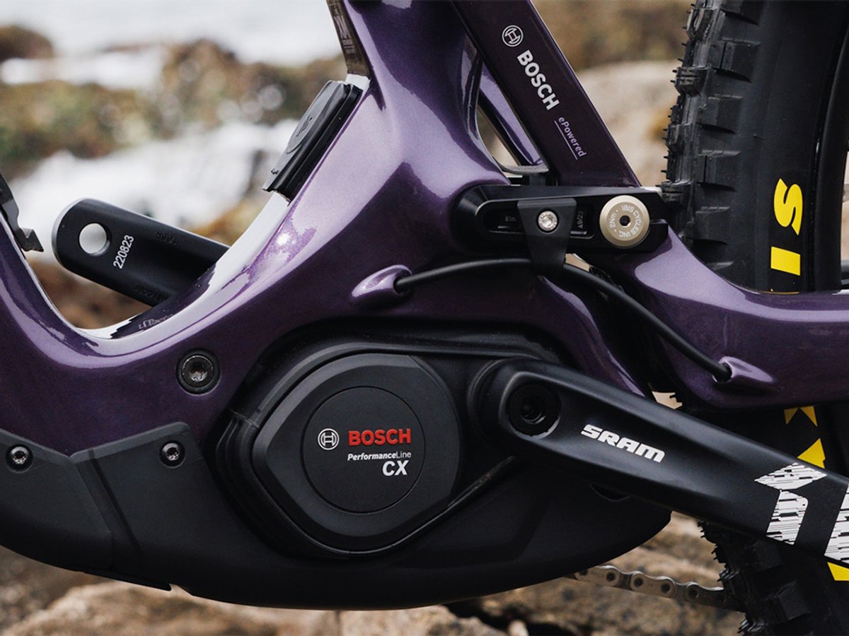 Close-up of  electric motor on full-suspension eMTB frame on dirt trail terrain Option