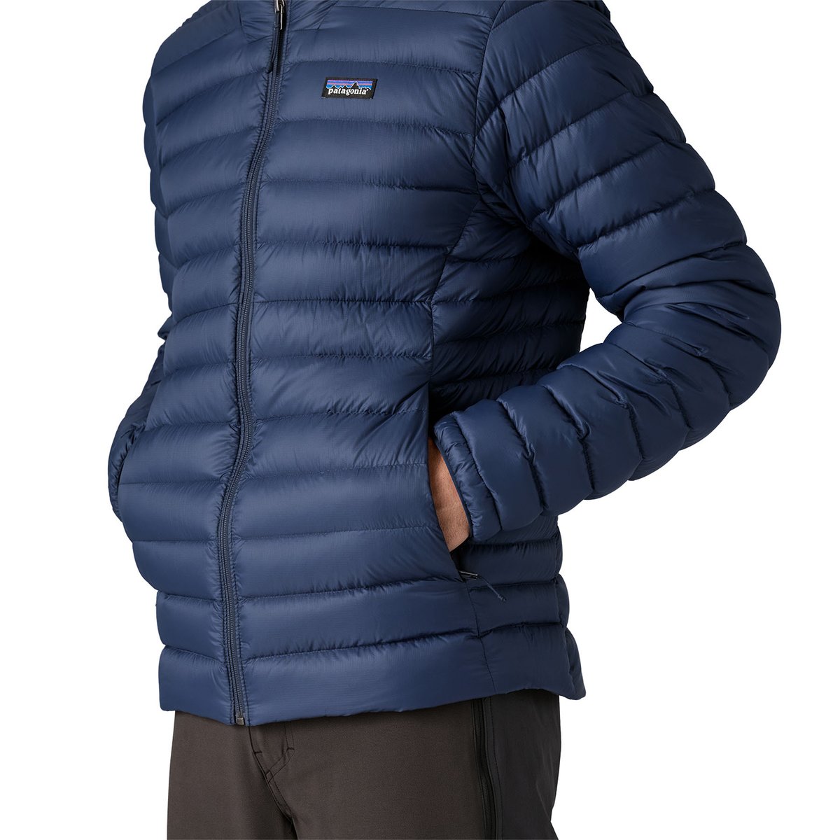 A person puts their hands into the Down Sweater Jacket handwarmer pockts