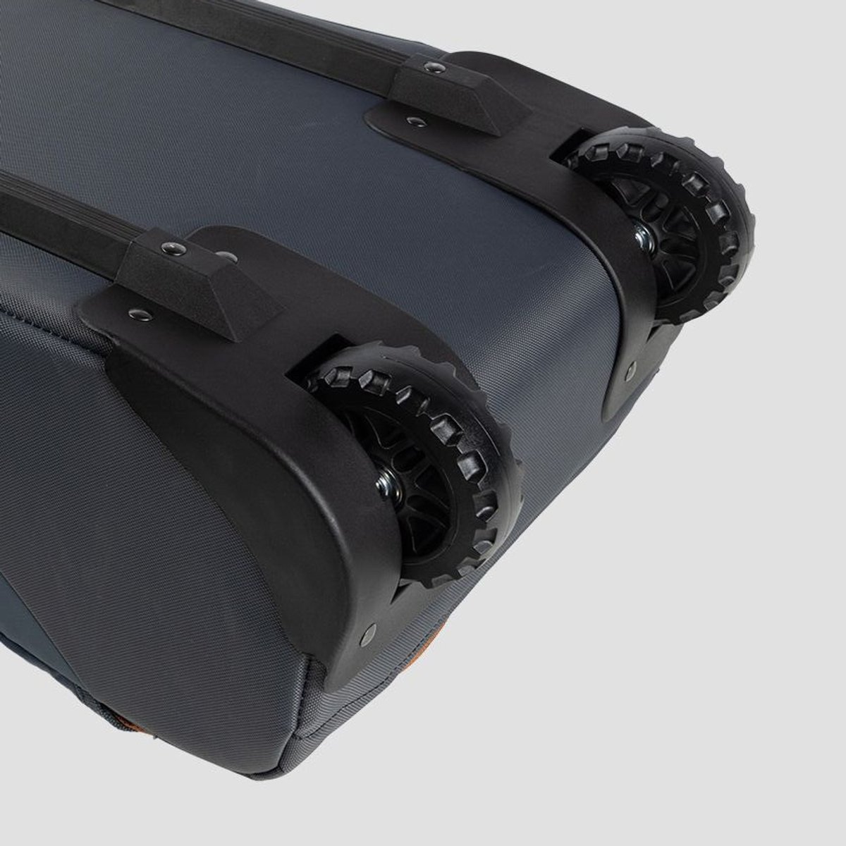 Close-up of oversized wheels on base of ski bag.