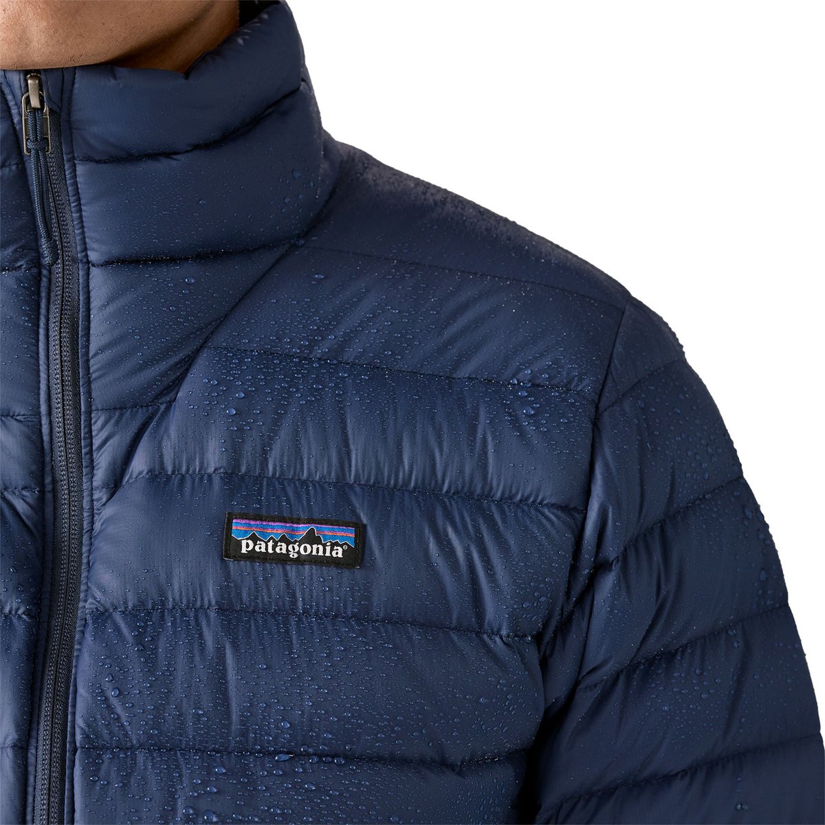 A closeup of water beading off the DWR finish of the Patagonia Down Sweater jacket