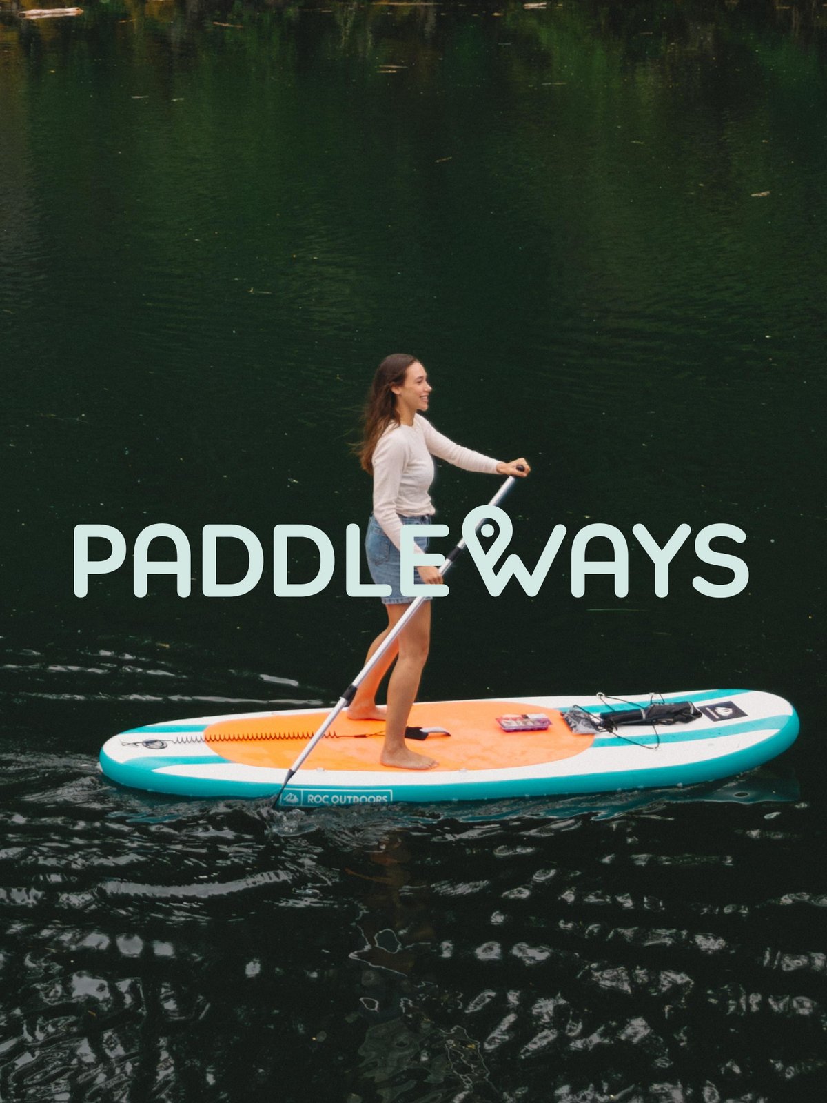 Woman paddleboarding on a dark, calm lake, featuring the Paddleways logo.