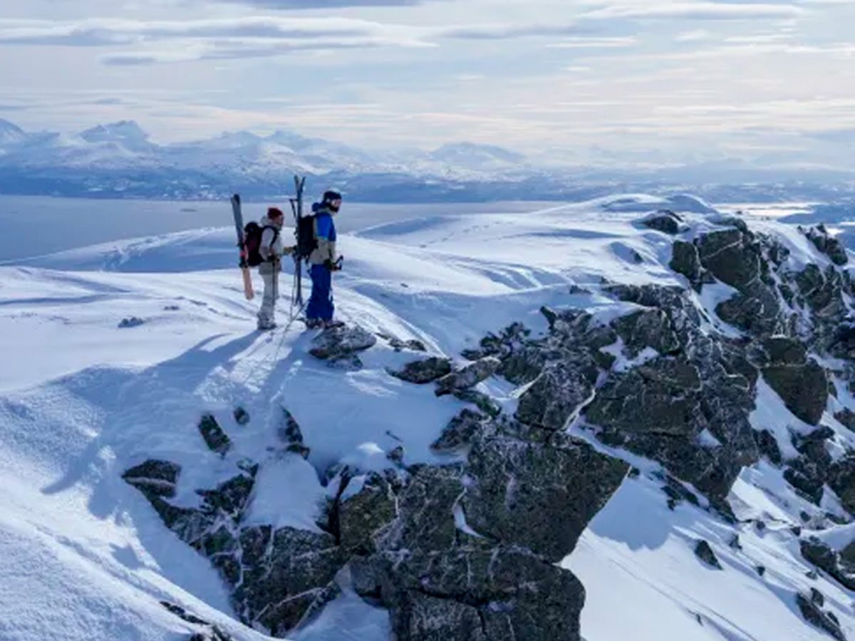 for Image

Group of mountaineers with skis standing on snowy alpine peak overlooking frozen lakes and mountain range in winter backcountry terrain.