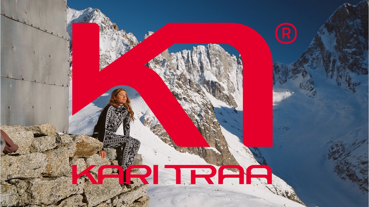 Woman in Kari Traa base layer overlooking snowy mountain terrain with Kari Traa logo overlay