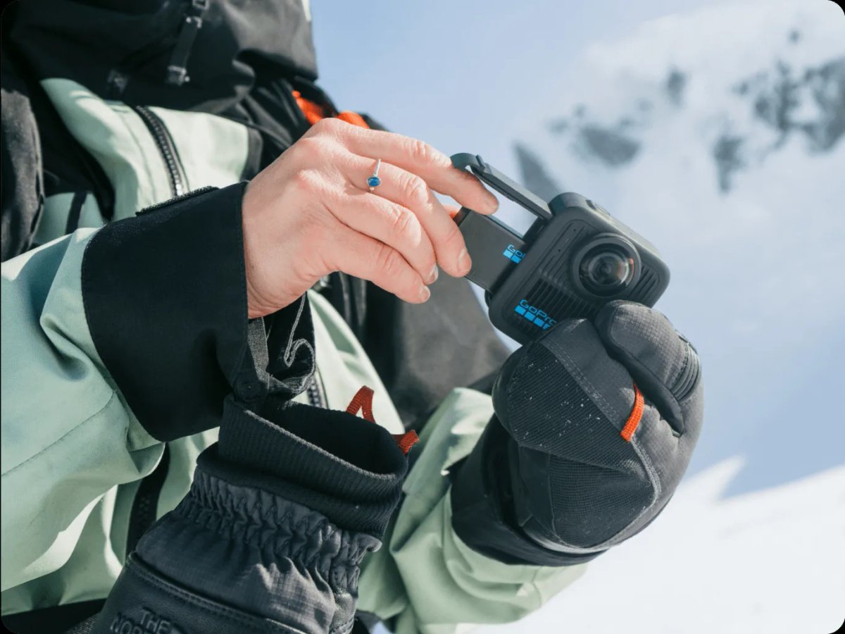 Someone placing battery inside the camera.