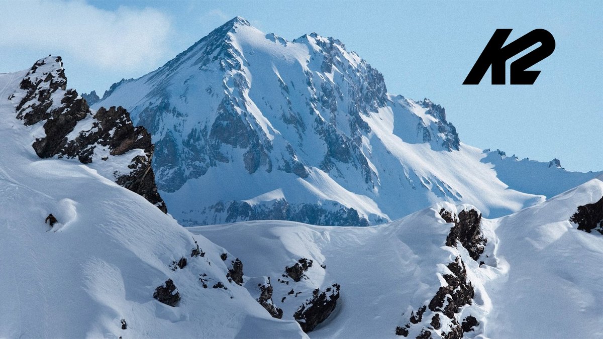 A skier descends a steep, pristine mountain slope, with the K2 logo overlaid.