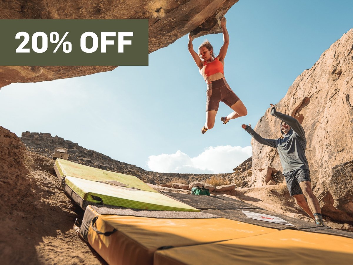 A man on a mountain bike looks over his shoulder.  A promotional flag says 20% off in the top right corner.