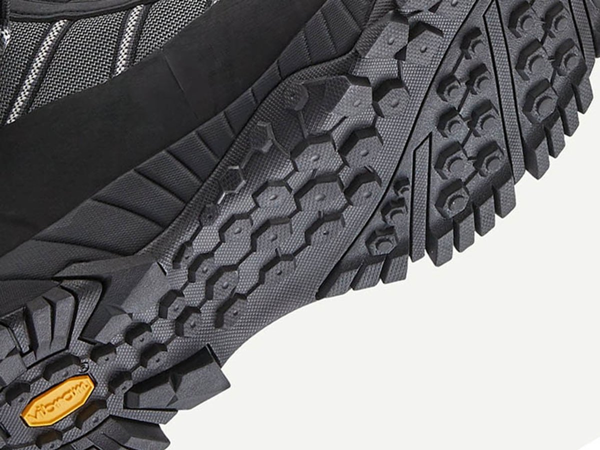 Close-up of the boot's Vibram outsole, showing hexagonal lug pattern and orange Vibram logo tab.