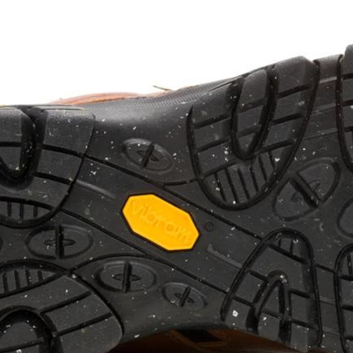 Close-up of the Vibram outsole on a Merrell hiking shoe, showing rubber lugged tread.