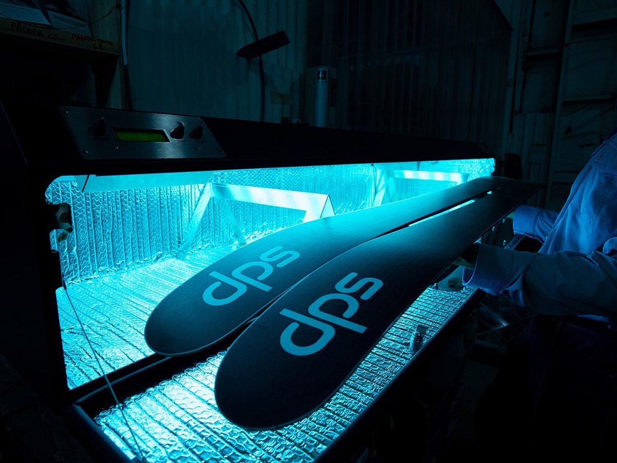 Pair of skis curing under the DPS Phantom Glide UV station